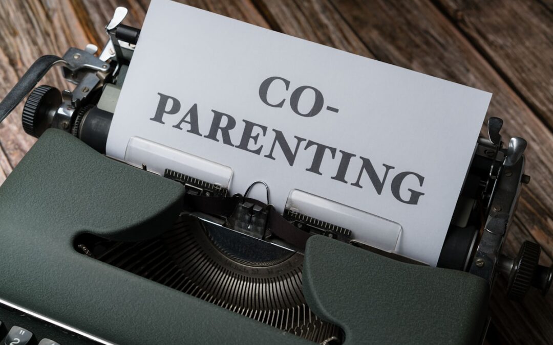 a close up of a typewriter with a paper that says co - parenting
